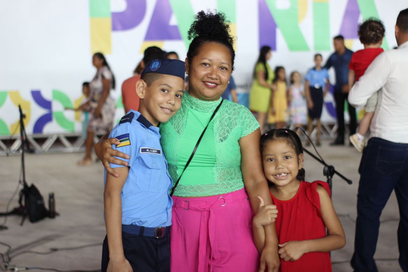 Albert Ronald, de 12 anos, com a mãe e irmã, durante a cerimônia de aposição de luvas