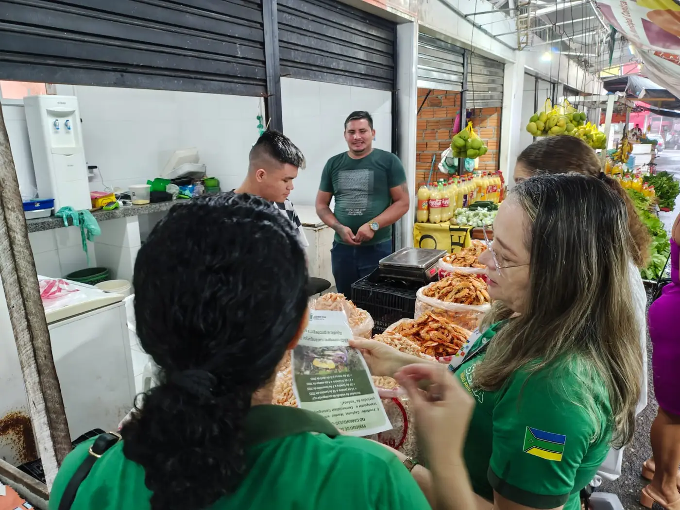 Cartazes com orientações sobre o defeso são distribuídos para os feirantes. Período inicia nesta quinta-feira, 27